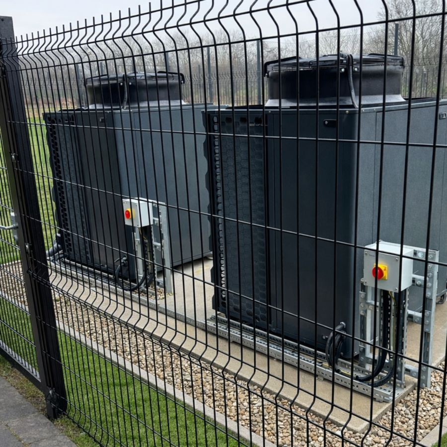 Commercial heat pump units installed within a secure fenced compound